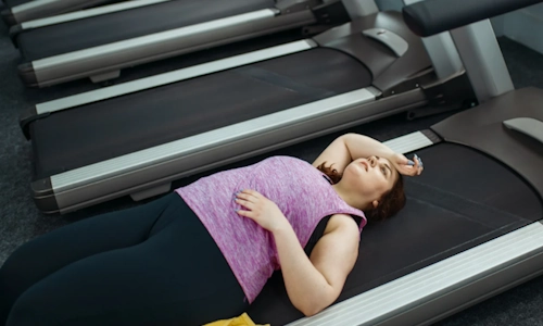 middle age woman looking tired on treadmill low hormone